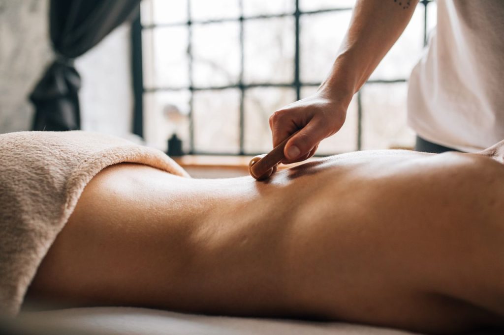 A soothing body massage in a serene indoor spa setting, enhancing relaxation.