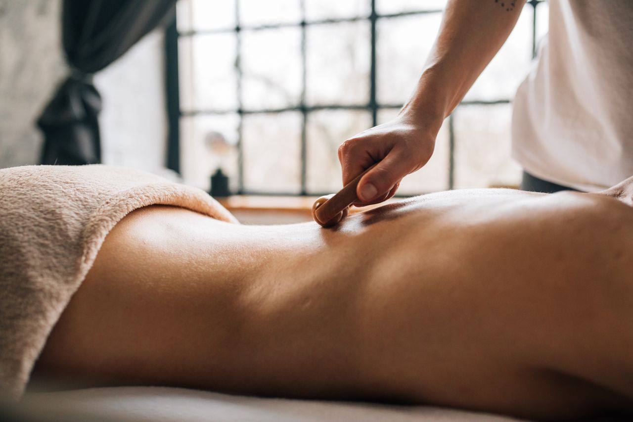A soothing body massage in a serene indoor spa setting, enhancing relaxation.